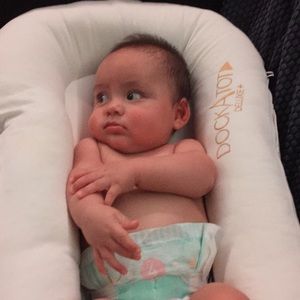 DockATot, well used. Has a milk stain.